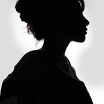 Striking black and white silhouette of a woman in profile, showcasing graceful features.